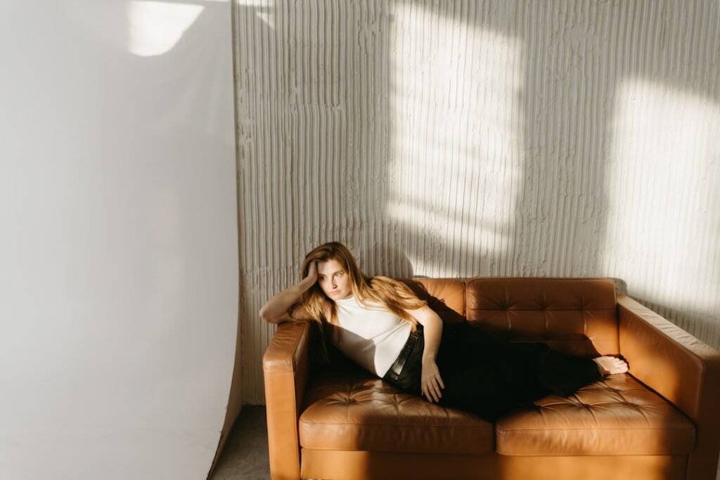 Woman resting on a couch in soft natural light