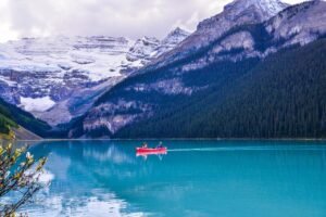 banff, banff national park, lake louise, rocky mountains, canadian rockies, canoeing, lake, landscape, nature, outdoors, red canoe, hiking, canadian nature, spring landscape, recreation, park guide, rowing, park benches, grassy area, clear water