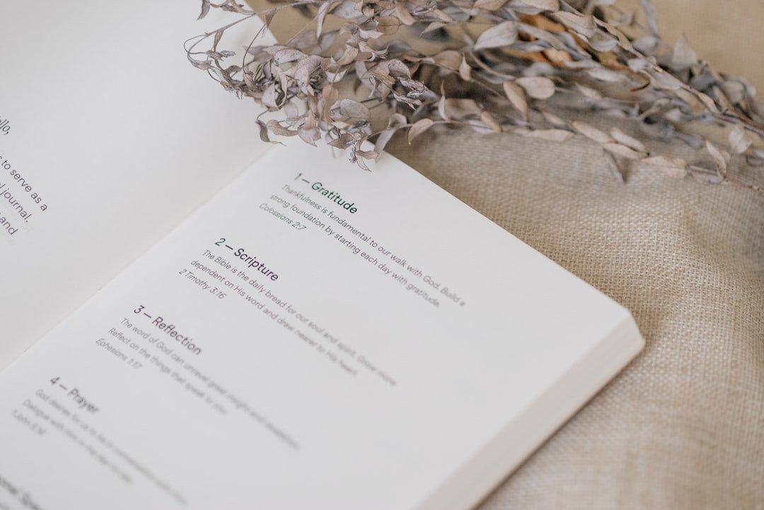 Open journal and botanical arrangement in soft natural light